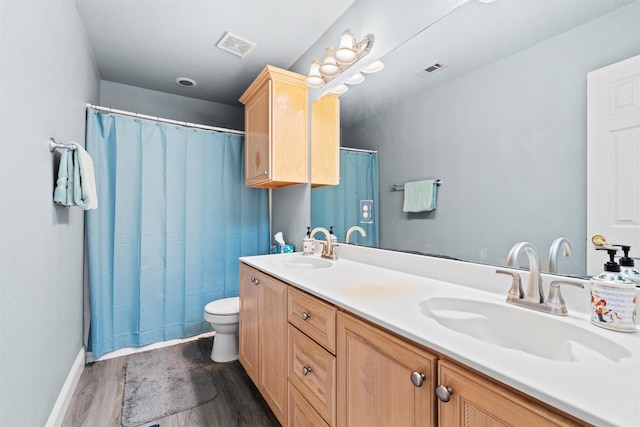 bathroom with vanity, hardwood / wood-style floors, and toilet