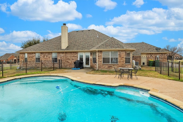 view of pool with grilling area and a patio area