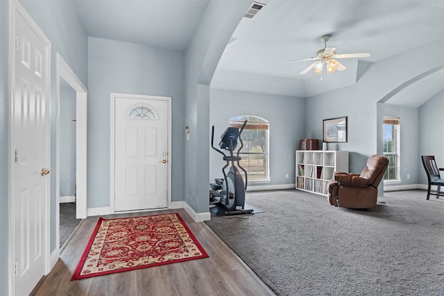 entrance foyer featuring ceiling fan, plenty of natural light, and carpet floors