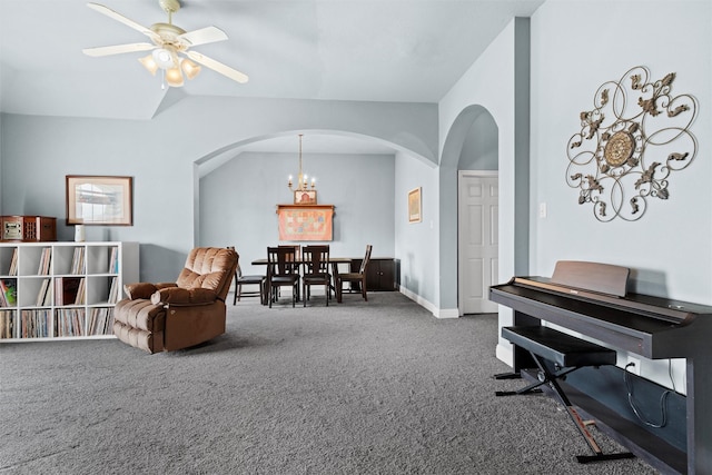 living area with ceiling fan with notable chandelier, lofted ceiling, and carpet floors