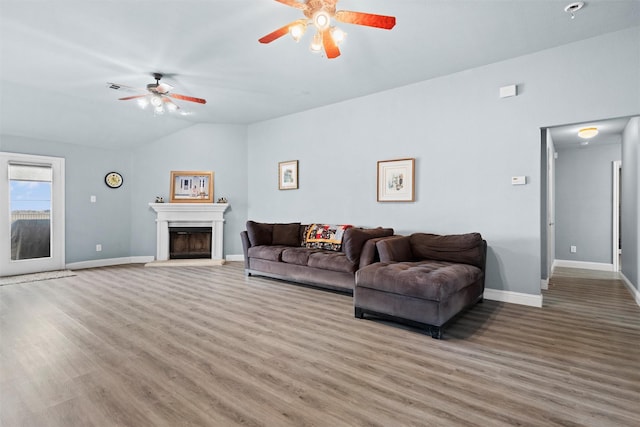 living room featuring hardwood / wood-style flooring, ceiling fan, and lofted ceiling