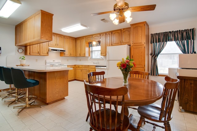 kitchen with ceiling fan, white appliances, and crown molding