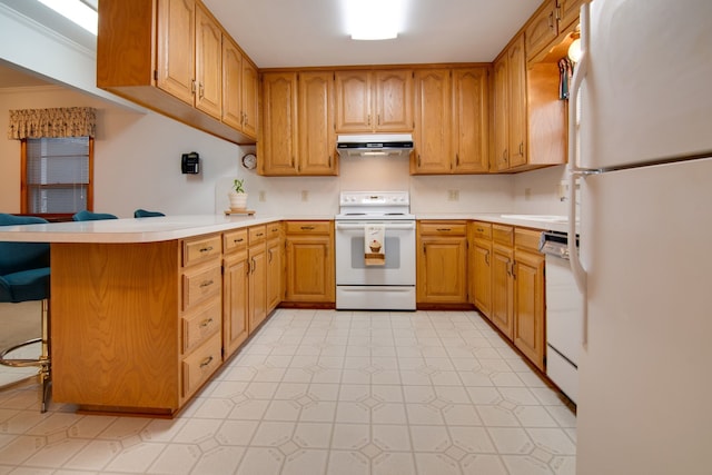 kitchen with crown molding, a breakfast bar area, white appliances, and kitchen peninsula