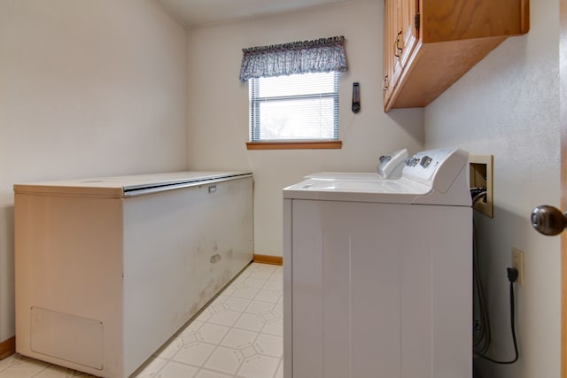 washroom featuring cabinets and separate washer and dryer