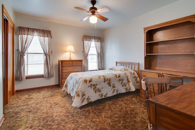 carpeted bedroom with ceiling fan and multiple windows