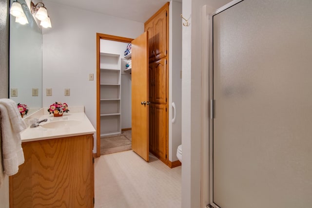 bathroom with vanity, toilet, and walk in shower