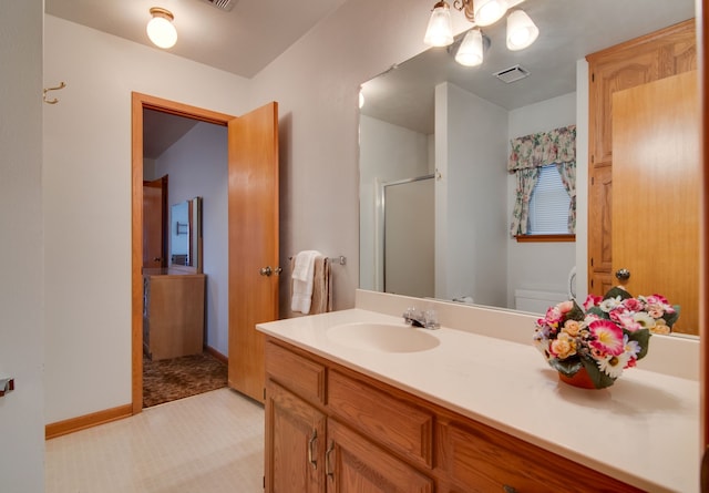 bathroom featuring vanity and a shower with door