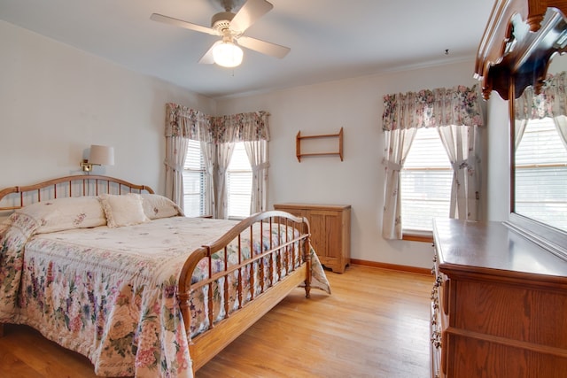 bedroom with ceiling fan and light hardwood / wood-style flooring