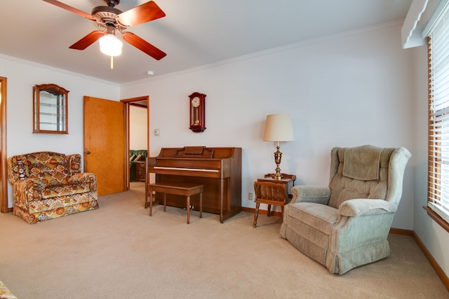 sitting room with crown molding, light colored carpet, and ceiling fan