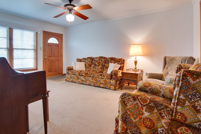 carpeted living room with ornamental molding and ceiling fan