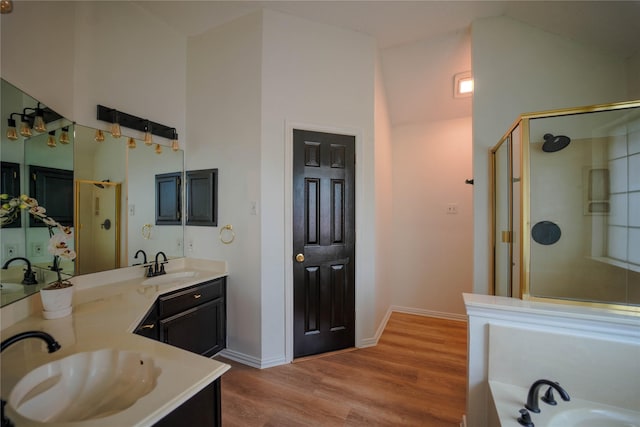 bathroom with vanity, wood-type flooring, high vaulted ceiling, and shower with separate bathtub