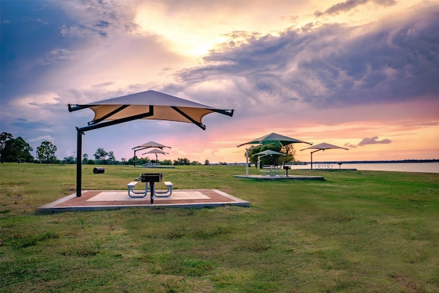 view of property's community featuring a yard and a water view