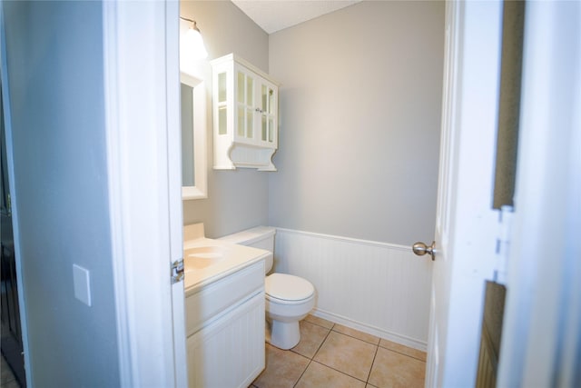 bathroom with vanity, tile patterned floors, and toilet