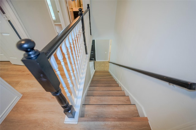 staircase with hardwood / wood-style floors