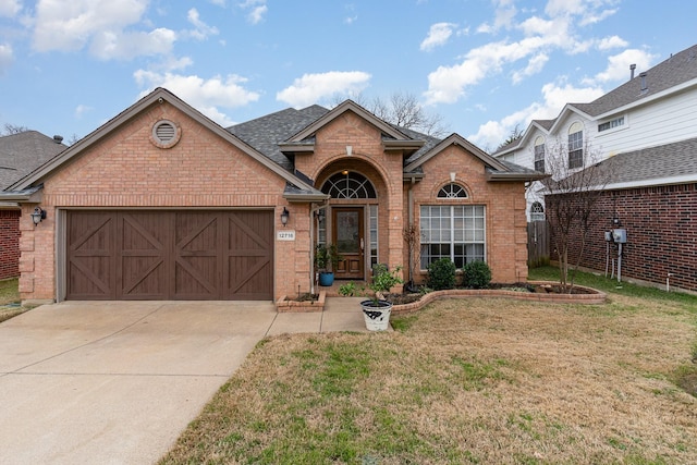 view of front of home featuring a garage and a front lawn