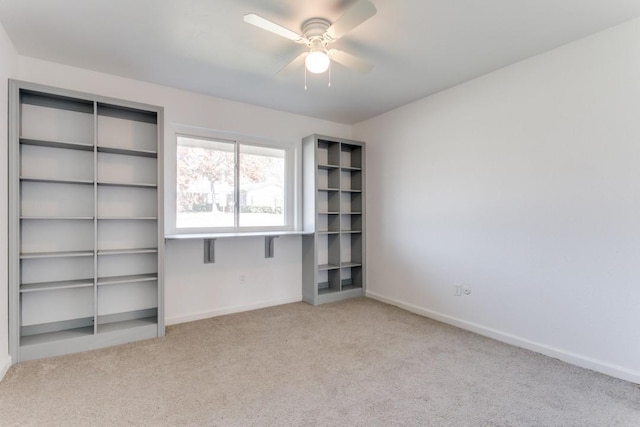 unfurnished bedroom with carpet, a closet, baseboards, and a ceiling fan