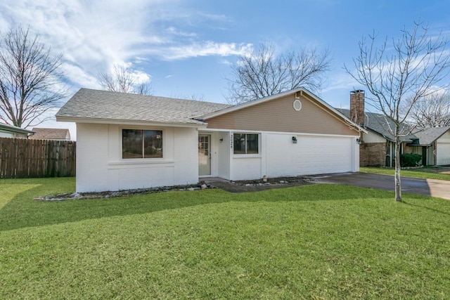 ranch-style home featuring a garage and a front yard