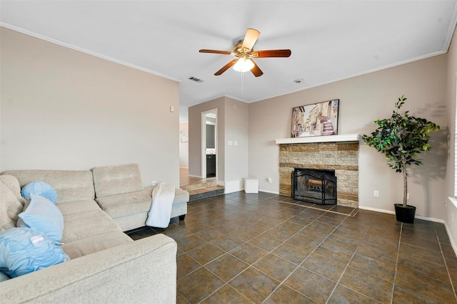 living room with a fireplace, ornamental molding, and ceiling fan