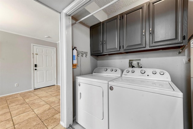 laundry room featuring cabinets, washing machine and dryer, and light tile patterned flooring