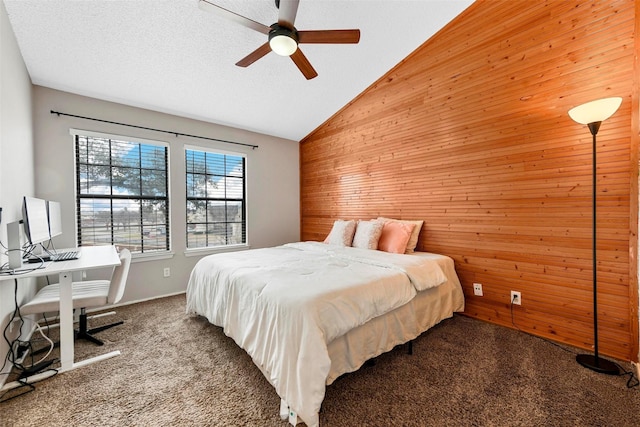 carpeted bedroom featuring ceiling fan, lofted ceiling, a textured ceiling, and wood walls