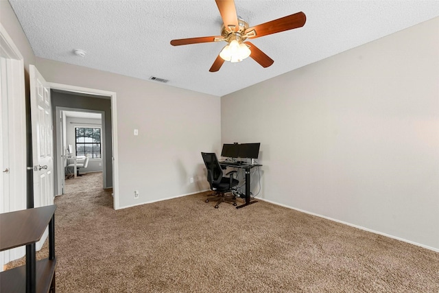 office space with a textured ceiling and carpet flooring