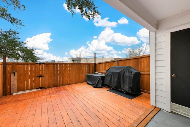 wooden deck with a grill