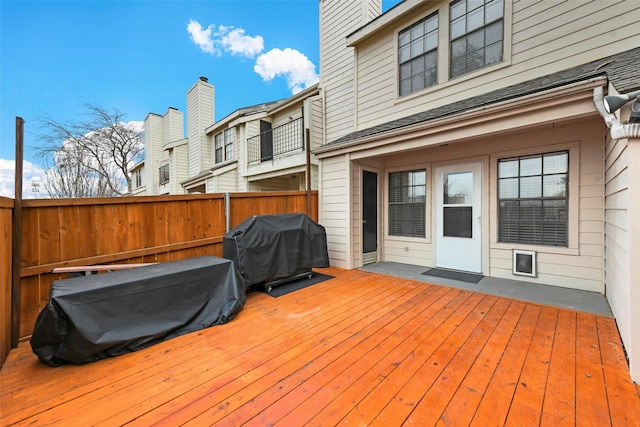 wooden deck featuring a grill