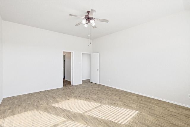 empty room with hardwood / wood-style flooring and ceiling fan