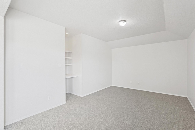 carpeted spare room featuring a textured ceiling