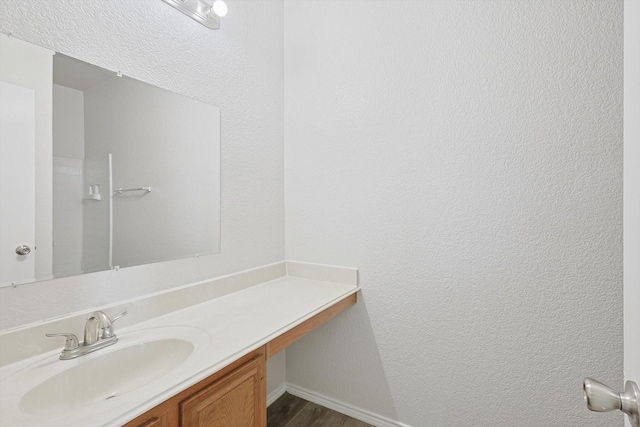 bathroom with vanity and hardwood / wood-style floors