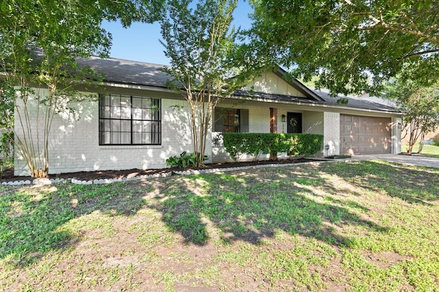 ranch-style house featuring a garage and a front lawn