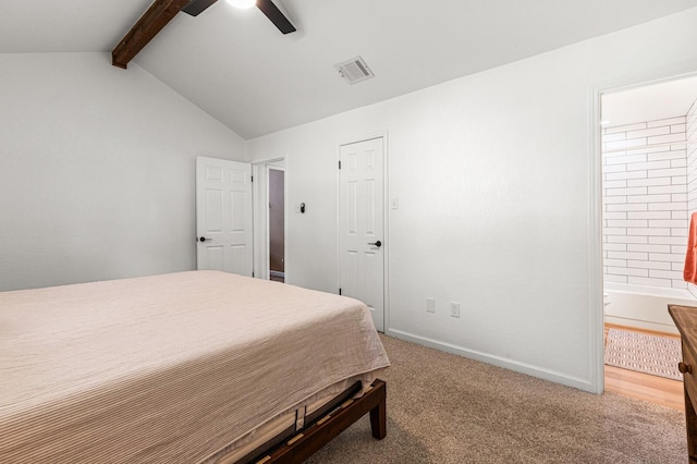 carpeted bedroom featuring lofted ceiling with beams, ceiling fan, and ensuite bath