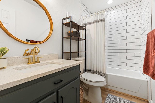 full bathroom with shower / bathtub combination with curtain, vanity, hardwood / wood-style floors, and toilet