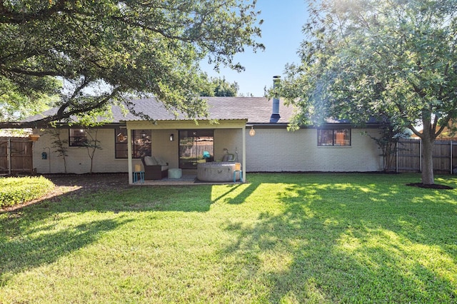 rear view of property featuring a yard