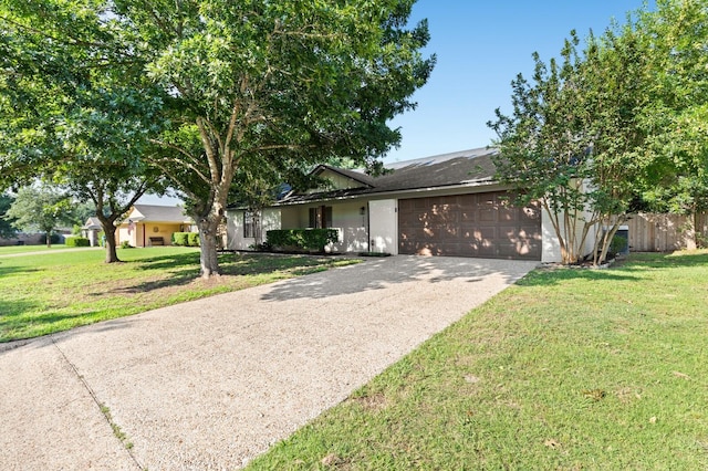 ranch-style home with a garage and a front lawn