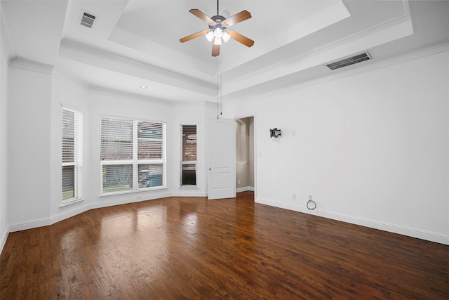 spare room with dark hardwood / wood-style flooring, crown molding, a raised ceiling, and ceiling fan