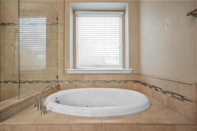 bathroom featuring a relaxing tiled tub