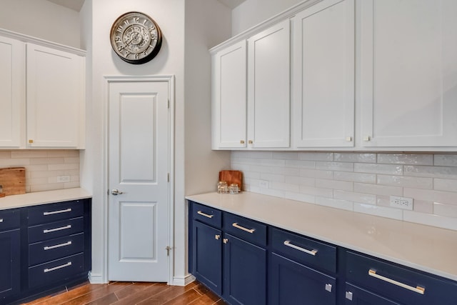 kitchen featuring white cabinetry, decorative backsplash, and blue cabinetry