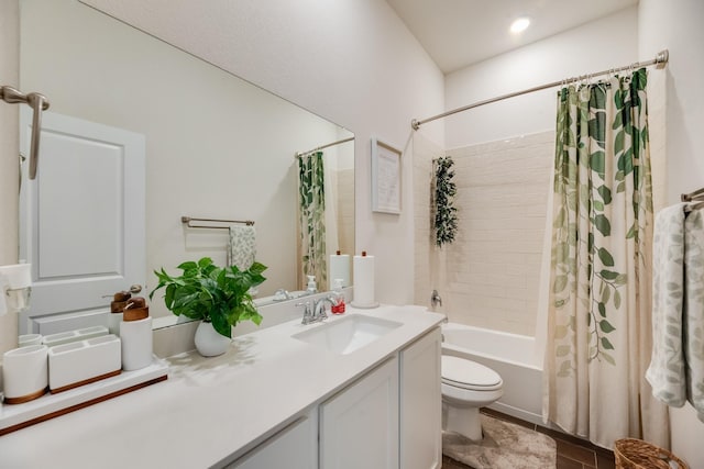 full bathroom with vanity, shower / bath combination with curtain, and toilet