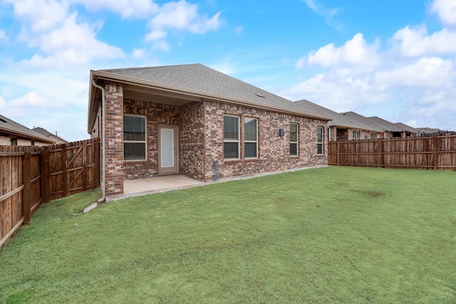 rear view of property featuring a patio and a yard