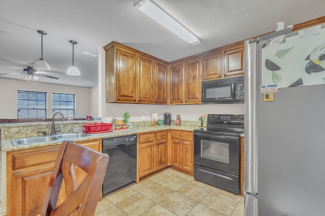 kitchen featuring light tile patterned flooring, black appliances, sink, light stone counters, and ceiling fan