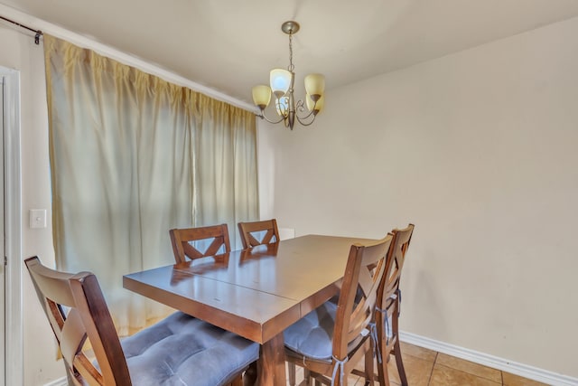 tiled dining room featuring an inviting chandelier