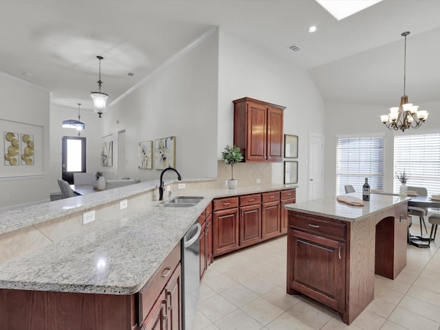 kitchen featuring light stone counters, a center island, sink, and dishwasher