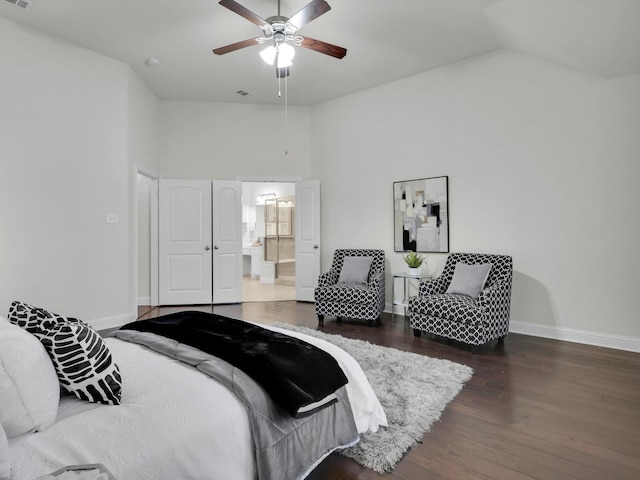 bedroom with ceiling fan, dark hardwood / wood-style floors, high vaulted ceiling, and ensuite bath