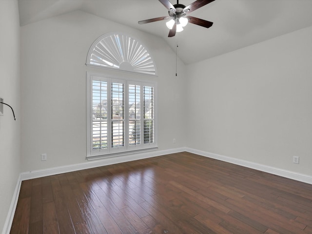 empty room with dark wood-type flooring, ceiling fan, and vaulted ceiling