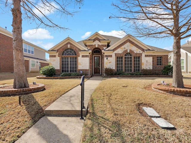 ranch-style home featuring a front yard