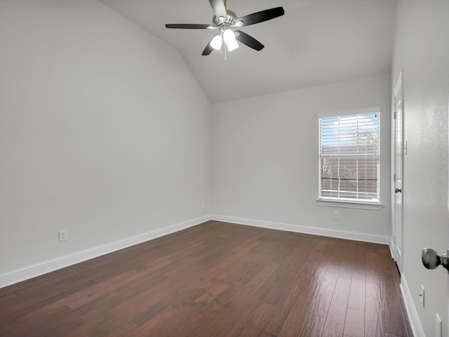 spare room featuring vaulted ceiling, dark wood-type flooring, and ceiling fan