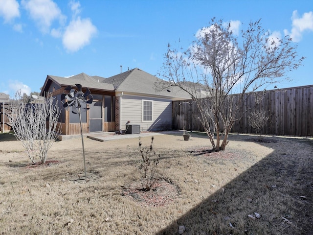 back of property featuring a yard and a patio area