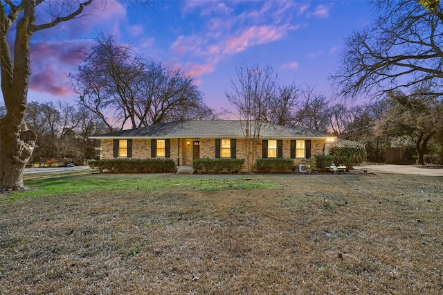 ranch-style home with a yard