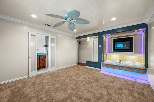 unfurnished bedroom featuring crown molding, carpet, ceiling fan, and ensuite bath